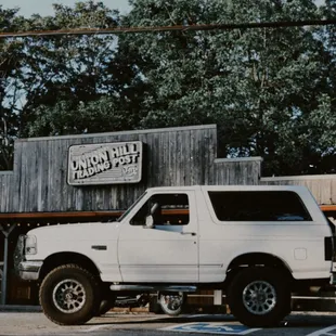 a white truck parked in front of a building