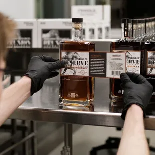a man in a blue shirt and black gloves