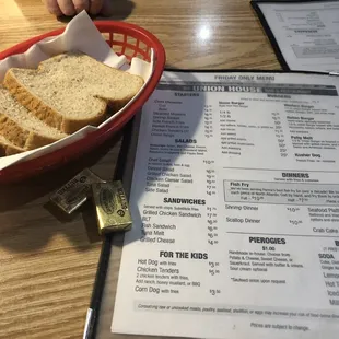 a basket of bread and a menu