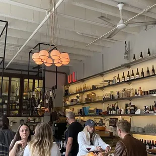 people sitting at tables in a restaurant