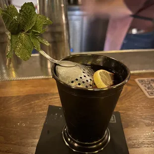  a cocktail in a metal cup