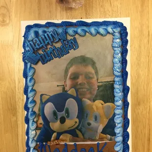 a birthday cake with a photo of a man and a teddy bear