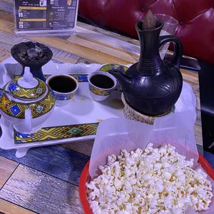 a tray of popcorn and a teapot