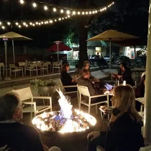 Outside patio with fire pits and heating lamps