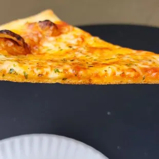 Cheese pizza Slice, side view to show its thinness and crispyness