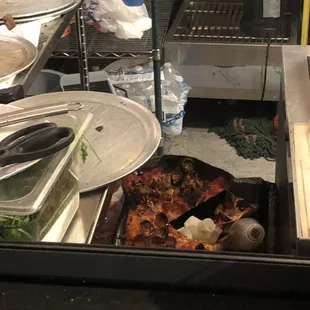 The charred/not charred pizza in the trash.