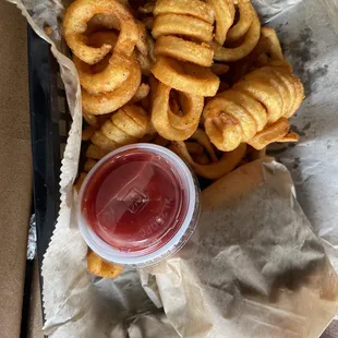 a basket of onion rings and ketchup
