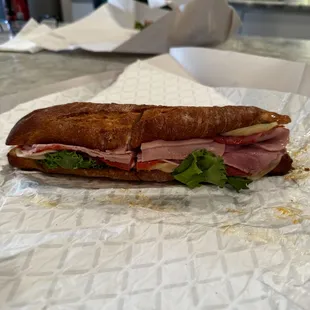 1919 Italian: Ham, capicola, pepperoni, provolone, lettuce, onion, hot peppers, and deli oil on a rustic baguette.