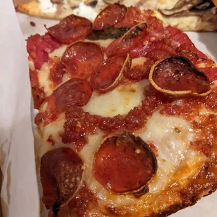 a slice of pepperoni pizza