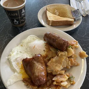 2 eggs over medium with sausage. Comes with potatoes and toast. Got coffee as well.