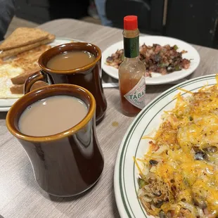 Vegetable hash browns, eggs over easy with toast and hash brown and a side of corn beef hash