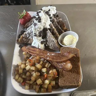 French toast with chocolate chips with side of scrapple bacon and home fries