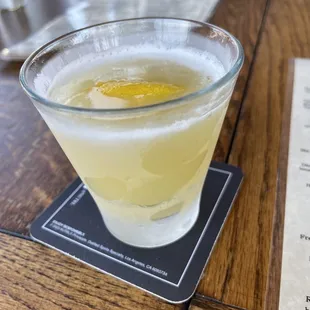 a drink in a glass on a coaster