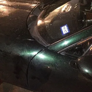 a car parked on a rainy night