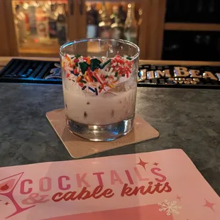 a cocktail glass with ice cream and sprinkles