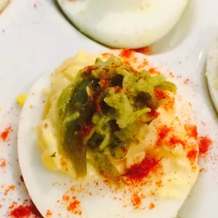Roasted Garlic and Chipoltle Deviled Eggs Topped with Asparagus Pesto and Smoked Paprika.