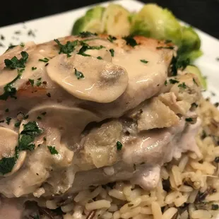Double Rib Pork Chop Filled with Mushroom, Sage, Rosemary Stuffing Topped with Sour Cream Gravy on Long Grain and Wild with Steamed Brussels