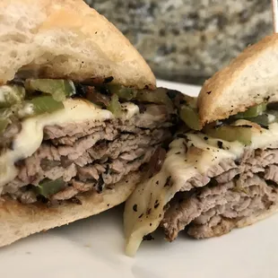 Grilled Tri Tip Sandwich with Peppers and Onions, Smoked Provolone Cheese, and Mayo on a Toasted Artisan French Roll