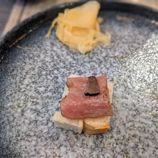 a piece of meat on a piece of bread