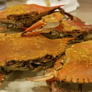 three crabs on a white plate