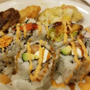 a plate of sushi and rolls