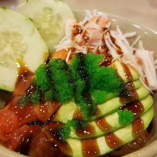 a bowl of sushi and vegetables