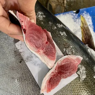 a person peeling a piece of meat