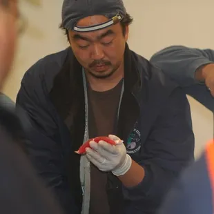A bidder inspects the sample before bidding.
