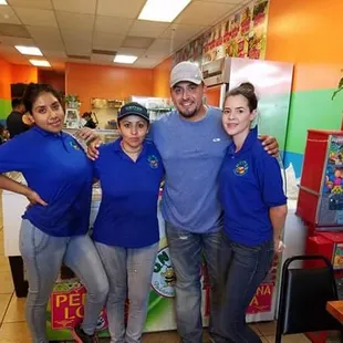 a group of people in blue shirts