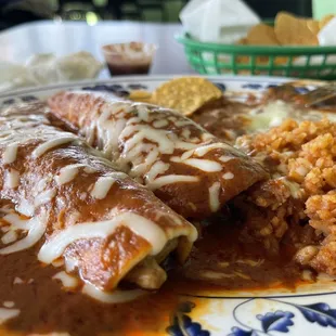 Enchilada plate comes with a side of chips if they give you a bottle water you'll get a two dollar service charge for that bottle