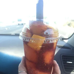 a hand holding a drink