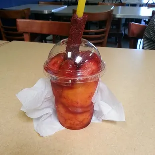 Mango ice cream with strawberries on top. Mangonada.