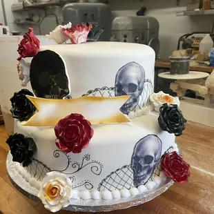 a cake decorated with skulls and roses