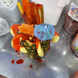 a pineapple decorated with fruit