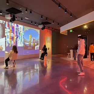 interactive room: learning about the olympics throughout the years (to the left) | screen to interviewing athletes (back left)