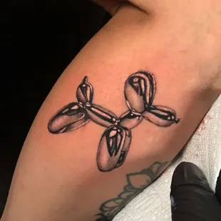 Striking black and grey chrome tattoo by Efrain 'EJ' Segoviano, showcasing a seamless fusion of artistic precision.