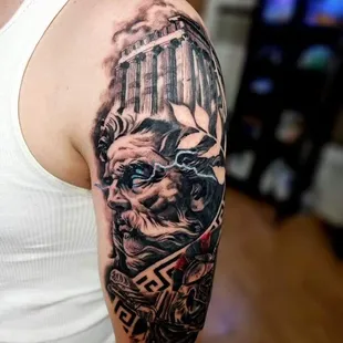 Intriguing black and grey realism and surrealism Greek-themed tattoo by the skilled artist Sole.