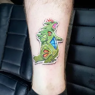 Stylish sticker tattoo by artist Sole, showcasing a sleek and minimalist design. The tattoo emulates the appearance of a classic sticker.