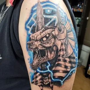 Captivating black and grey illustrative tattoo with subtle pops of color, expertly executed by artist Sole.