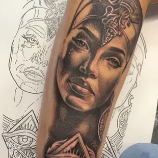 Intricate black and grey realistic tattoo by Efrain 'EJ' Segoviano, portraying the beauty and strength of a woman.