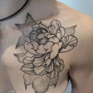 Exquisite black and grey dotwork and stippling chrysanthemum flower tattoo by Cory Sheets, showcasing meticulous artistry and subtle shading