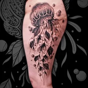 Dive into the subtle beauty of this fineline style jellyfish tattoo, a masterpiece crafted by John Lapides.