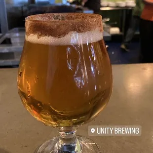 a glass of beer on a counter