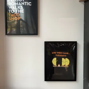 two framed posters on a wall