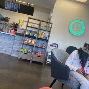 a woman sitting in a chair in a coffee shop