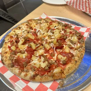 Pan pizza style with pepperoni, sausage, and pineapple