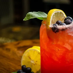 a drink with blueberries and lemons