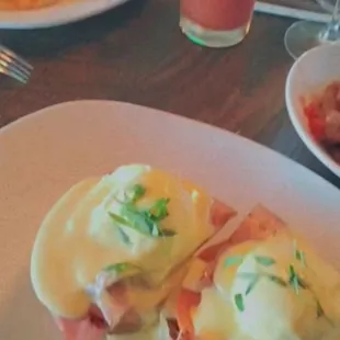 Egg Benny with a bloody Mary in the background.