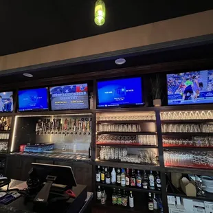 a bar with multiple televisions