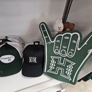 Caps and a foam "shaka" (instead of a pointing finger)!